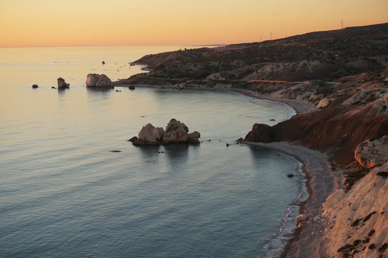 Petra tou Romiou and its bay at sunset.