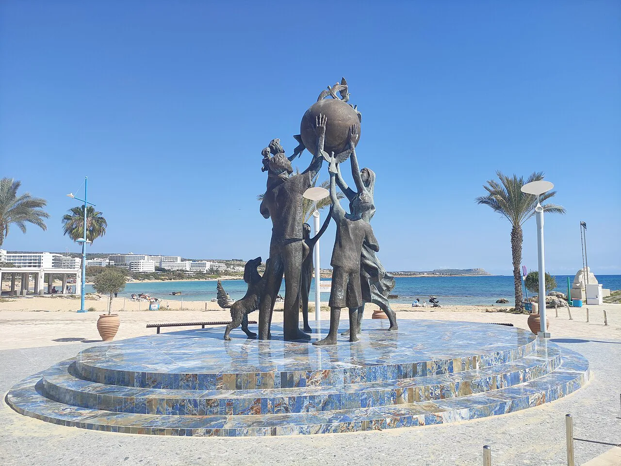 Bronze family statue by the harbour at Agia Napa.
