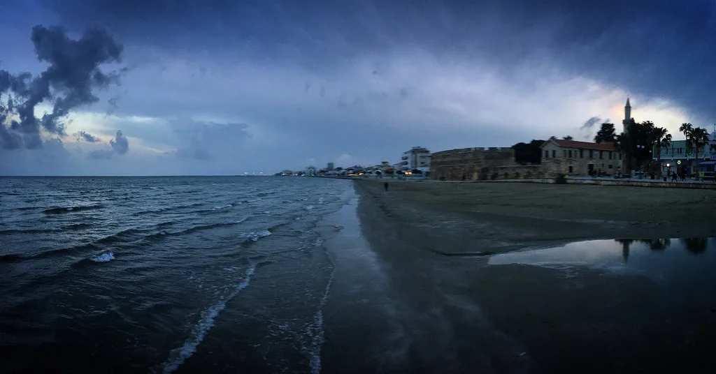 Beach and seafront of Larnaca at dusk.