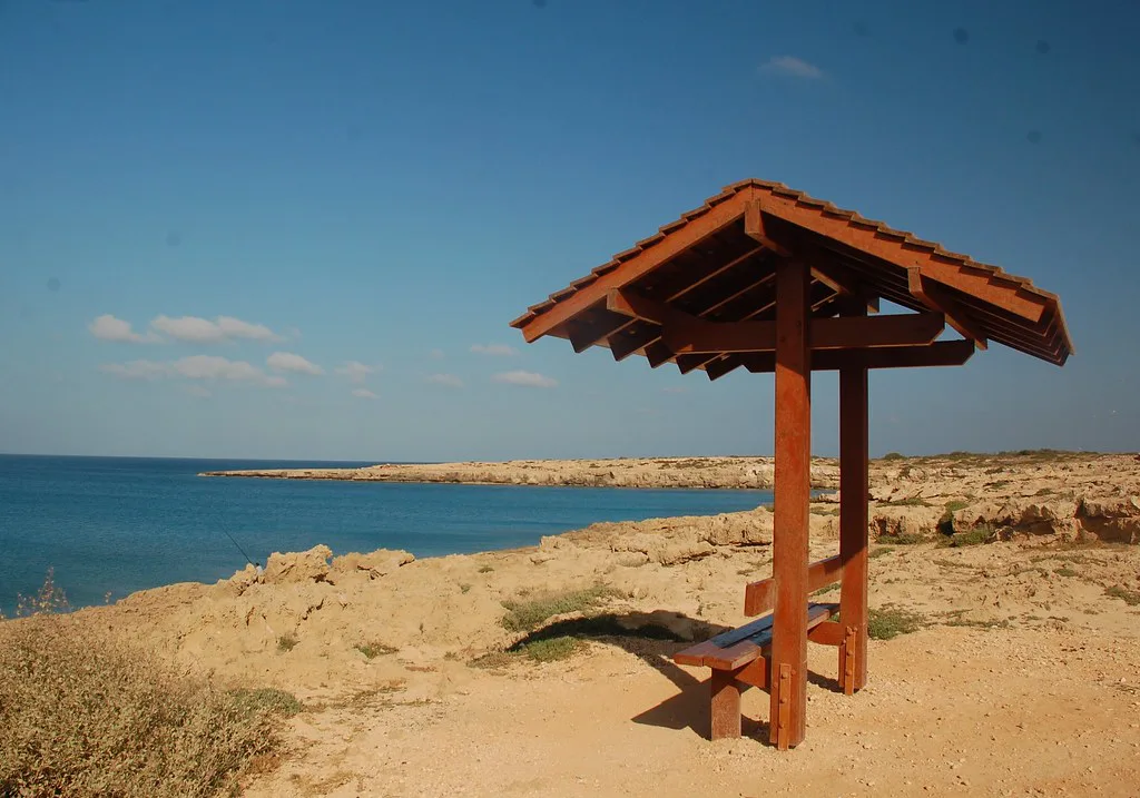 A wooden viewpoint shelter on the coast near Cape Greco.
